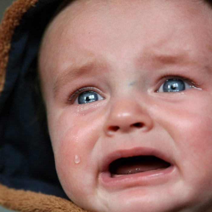 Emotional Close Up Of A Baby In Tears, Highlighting Raw Emotion And Vulnerability.