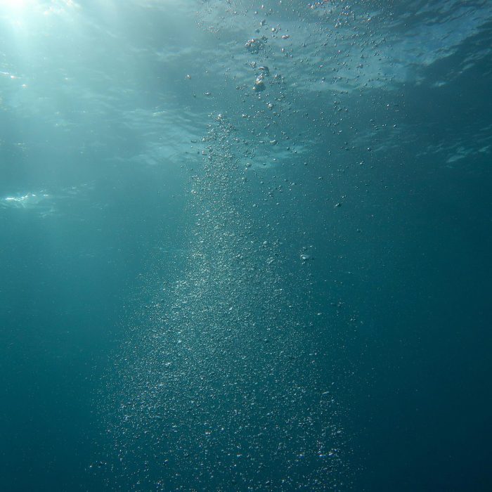 Peaceful Underwater Scene With Sunlight And Streaming Bubbles In The Ocean.