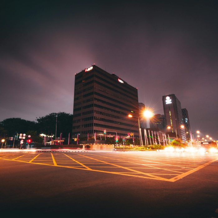 Vibrant Night Cityscape Of Jakarta With Illuminated Buildings And Light Trails.