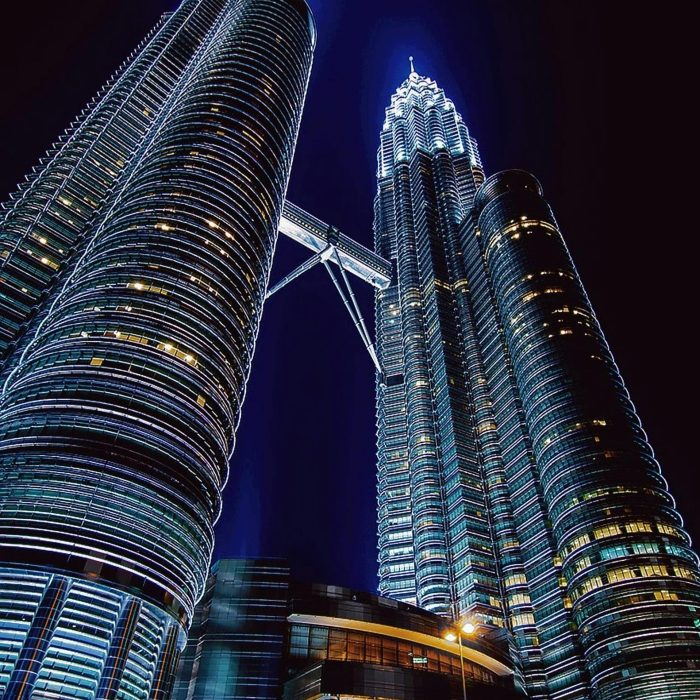Stunning Nighttime View Of The Illuminated Petronas Towers In Kuala Lumpur, Malaysia.