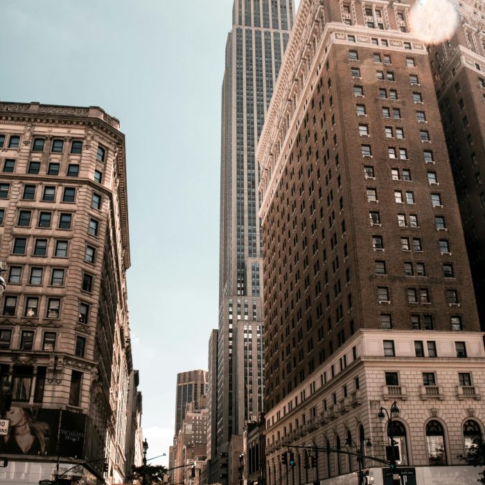 Bustling City Life With Iconic Skyscraper Under Clear Sky.