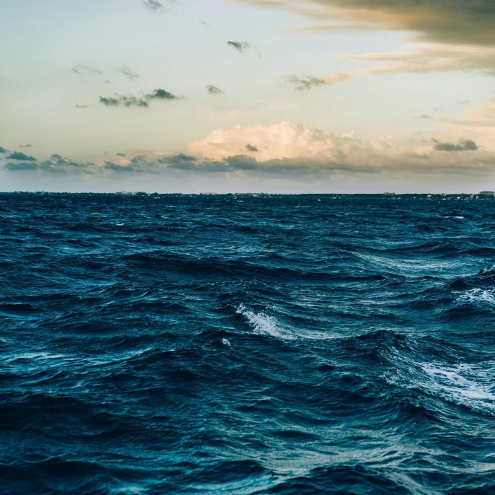 A Captivating View Of Ocean Waves Under A Dramatic Twilight Sky, Offering A Peaceful Seascape.