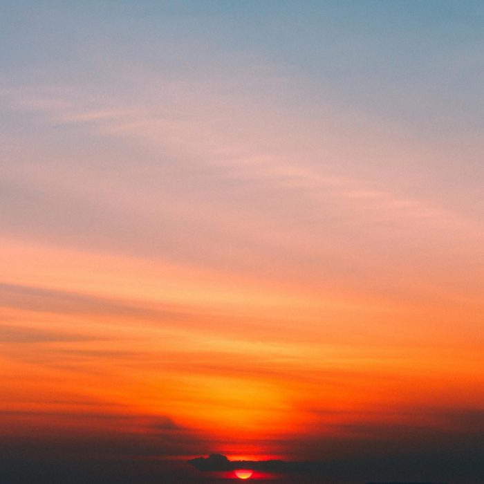 Dramatic Sunrise With Vibrant Orange And Blue Hues Painting The Sky, Creating A Serene And Peaceful Scene.