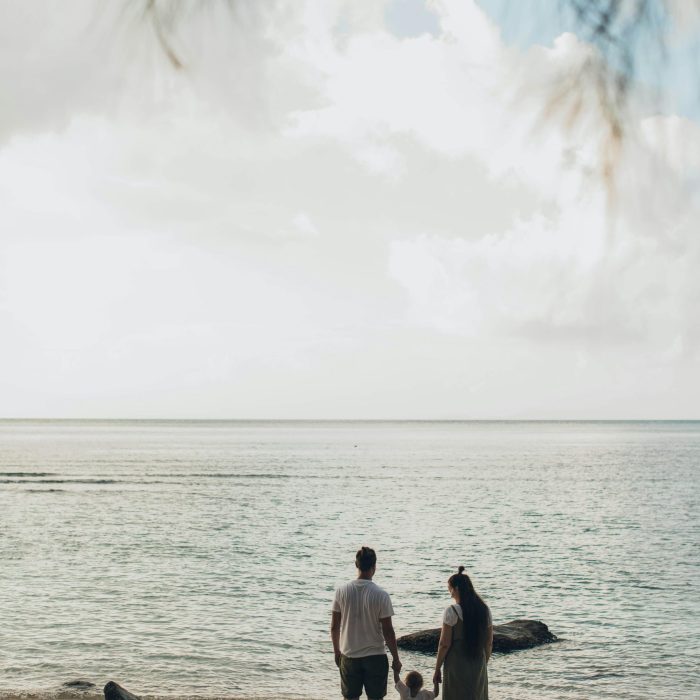 A Family Enjoys A Tranquil Day At The Beach, Highlighting Togetherness And Love.