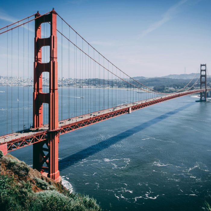 Iconic Golden Gate Bridge Over San Francisco Bay Under Clear Blue Skies, Showcasing Its Majestic Structure.