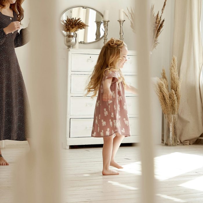 Charming Indoor Scene Of A Mother And Daughter Enjoying A Sunny Day In A Stylish, Airy Room.