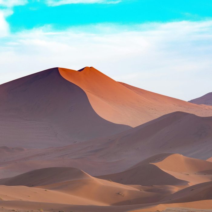 Capture The Serene Beauty Of Namibian Sand Dunes Under A Vibrant Sky. Perfect For Desert Themed Designs.