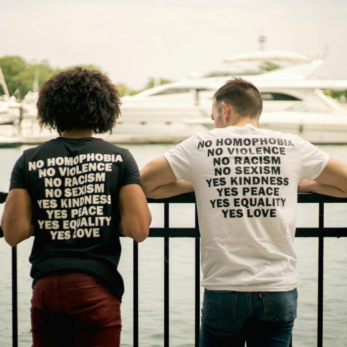 Two Men In Statement Shirts Promoting Love And Equality By A Marina In Chicago.
