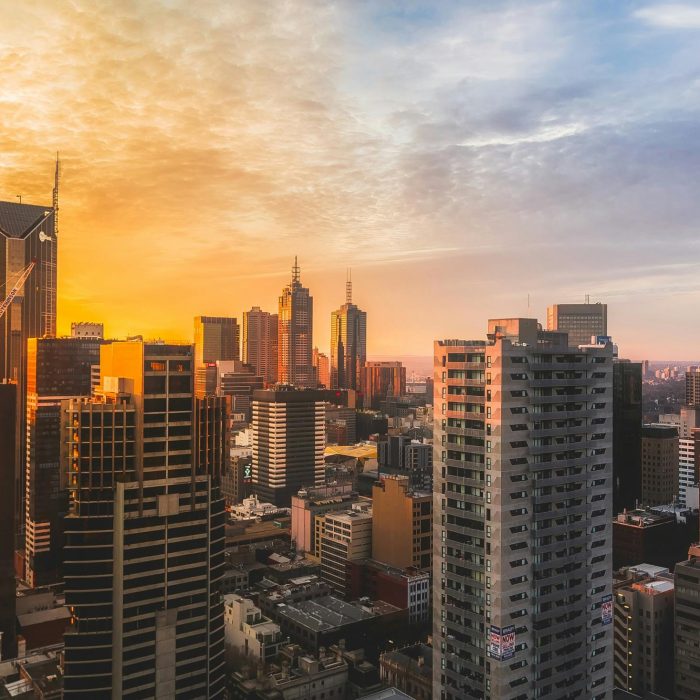 Stunning View Of Melbourne's Skyline At Sunset, Capturing Modern Skyscrapers And Warm Sky.