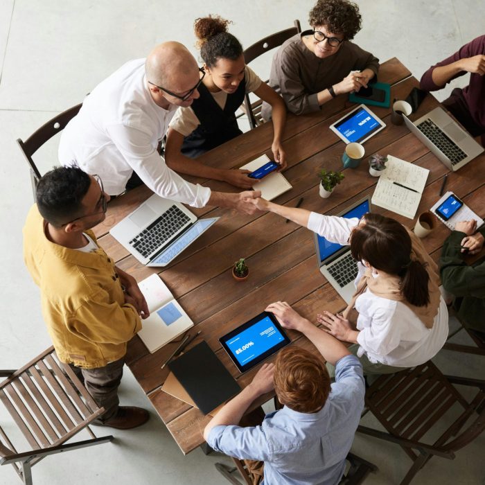 Overhead Shot Of A Diverse Team Collaborating In A Modern Office Meeting.