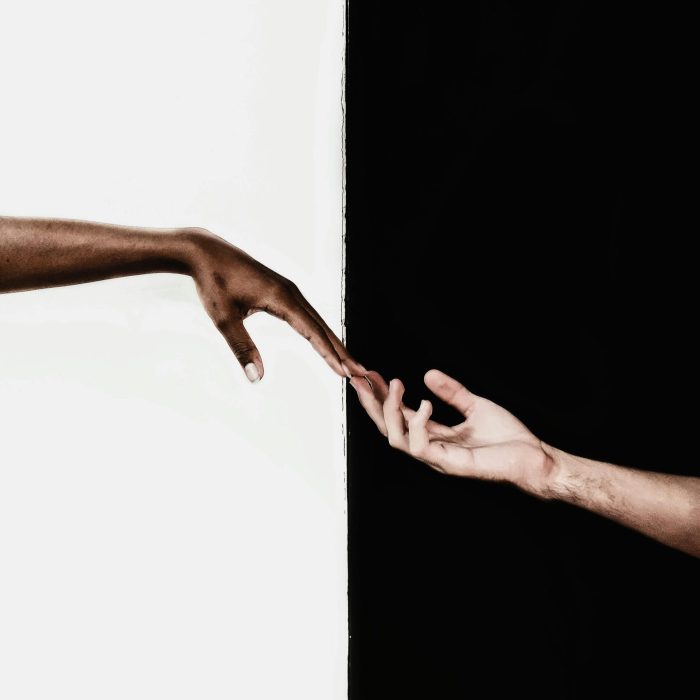 Symbolic Image Of Two Hands Reaching Toward Each Other, Representing Unity And Diversity.