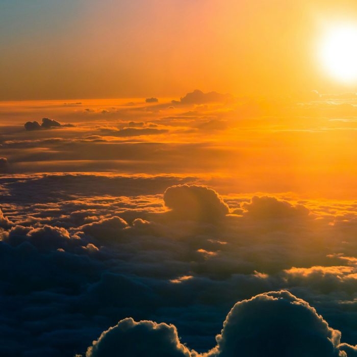 Stunning Aerial View Of A Dramatic Sunset Over Thick Clouds, Glowing Horizon.