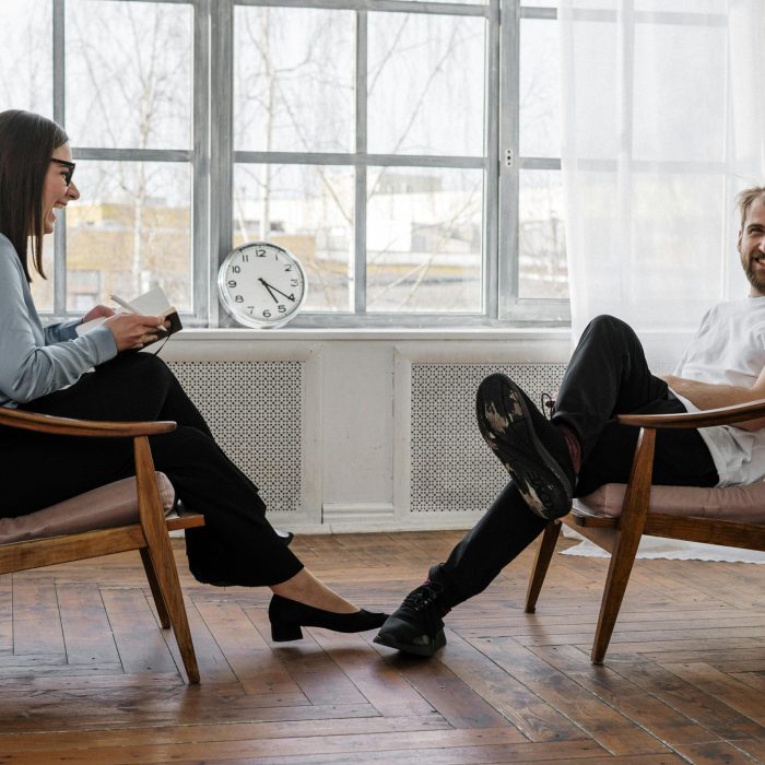 Counselor And Client In A Positive Therapy Session In A Well Lit Room.