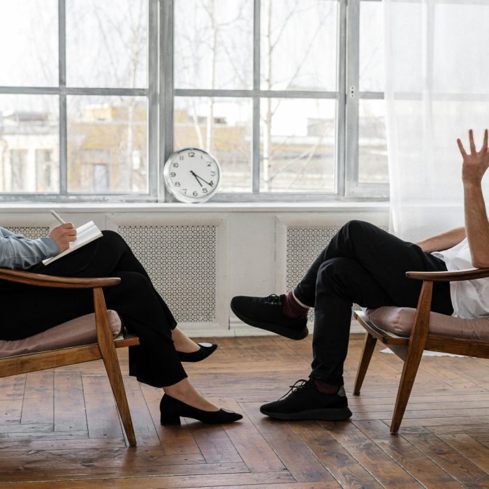 A Therapist Engaging In A Counseling Session With A Male Patient To Support Mental Health.