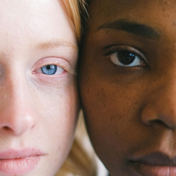 Intimate Close Up Of Two Women Of Different Ethnicities Showcasing Diversity.