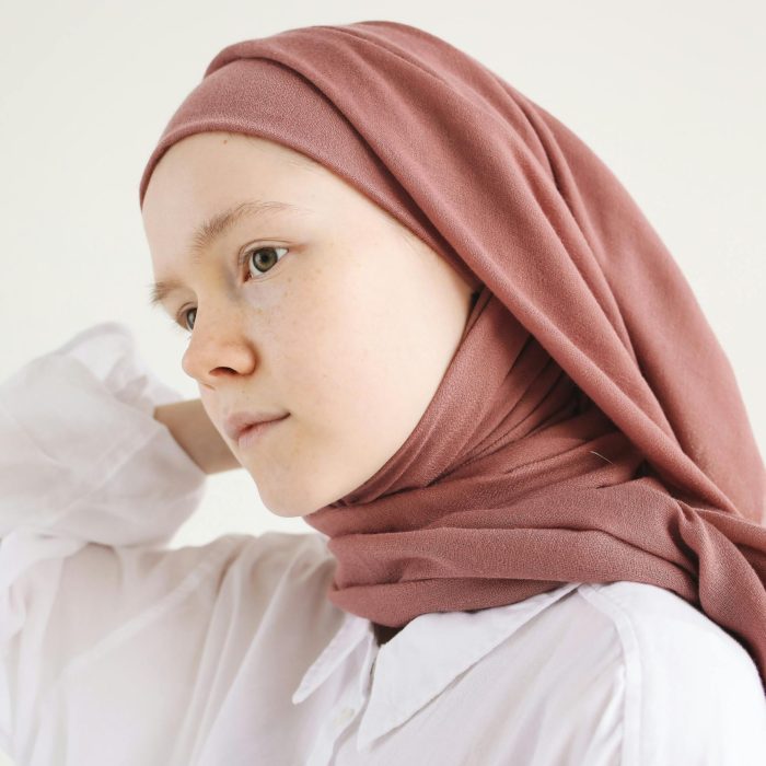 A Young Woman Wearing A Hijab, Posing In A Soft Light. Perfect For Lifestyle Or Cultural Themes.