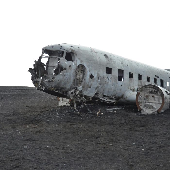 A Crashed Aircraft Wreckage In A Deserted Landscape, Evoking Mystery And History.