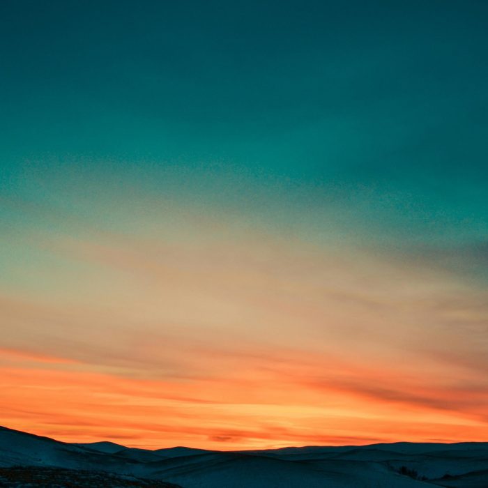 Capture Of A Stunning Twilight Sky With Colorful Gradients Over Gentle Hills.
