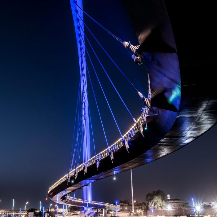 A Low Angle Shot Of An Illuminated Suspension Bridge Against A Clear Night Sky.