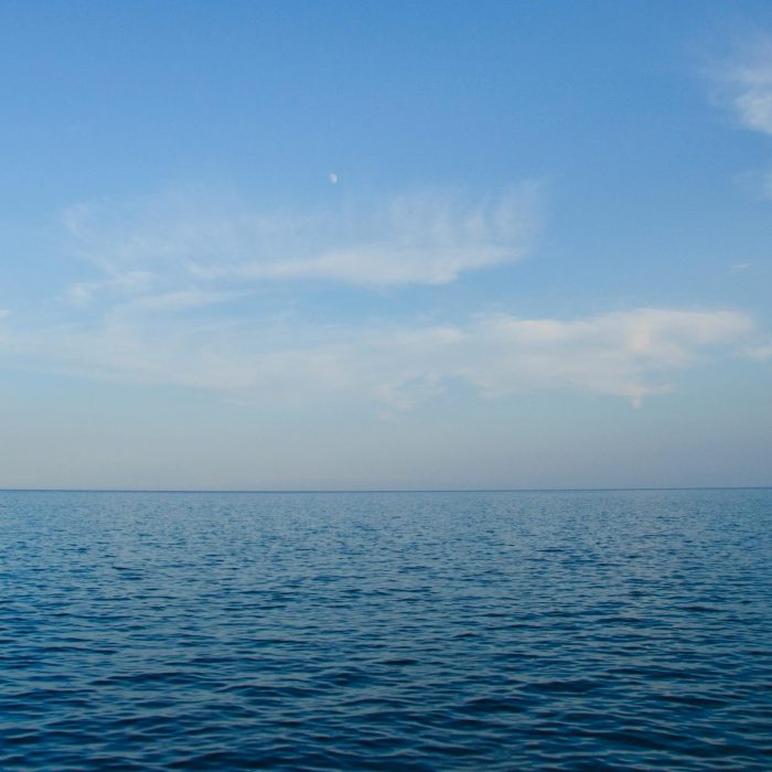 Calm Ocean View With Clear Blue Sky, Perfect For Backgrounds Or Wallpapers.